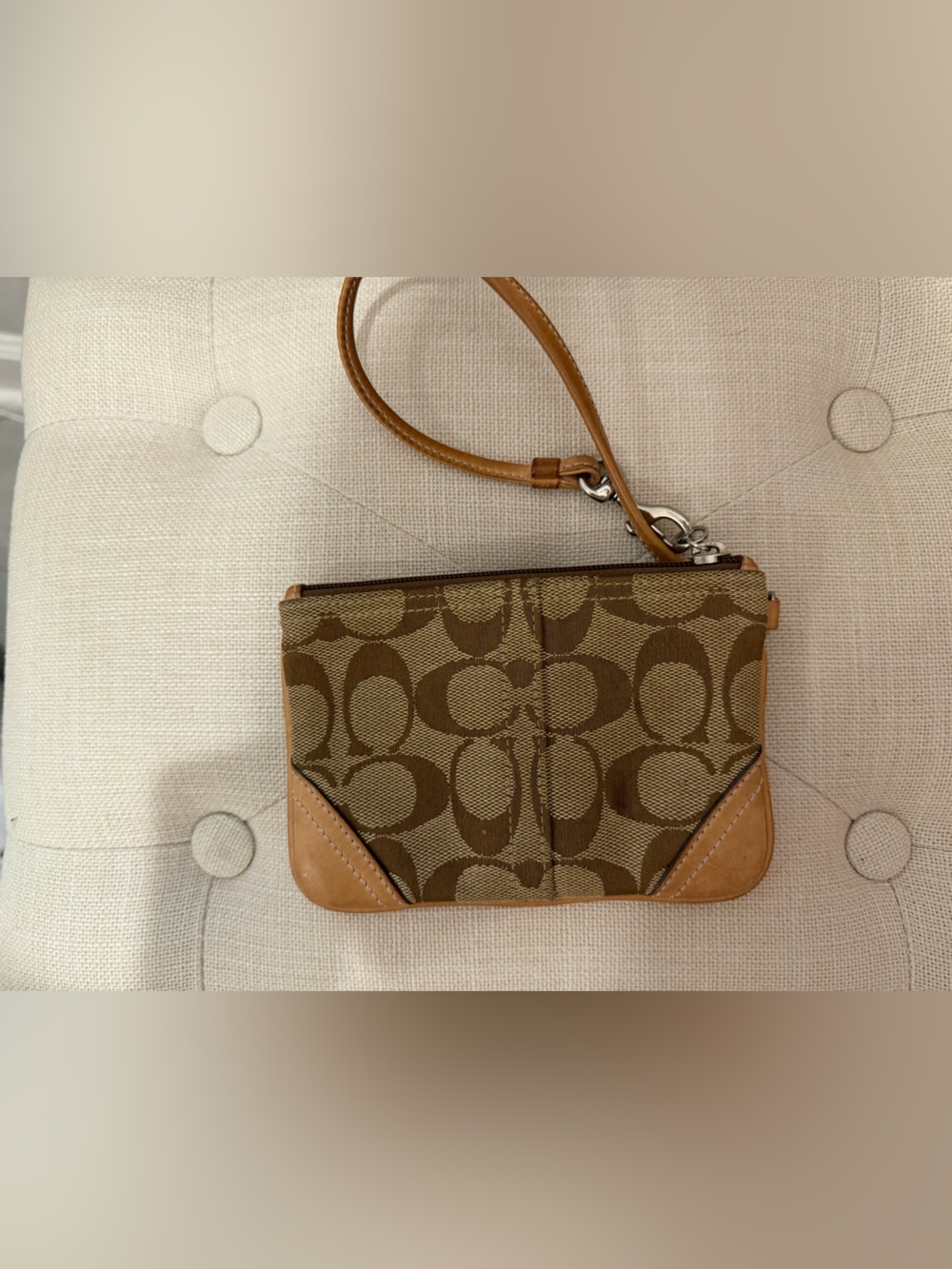 Coach signature jacquard wristlet featuring tan leather trim